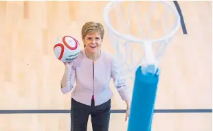  ??  ?? The first minister has a go at netball.