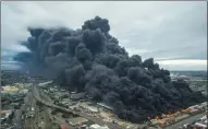  ?? PICTURE: SAPS ?? MILE HIGH: A warehouse containing petro-chemical wax pellets caught fire just off South Coast Road yesterday morning with two further warehouses engulfed in the inferno.