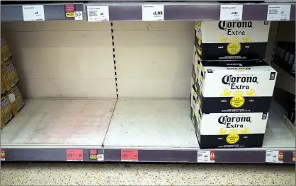 ??  ?? BARE: Shoppers stripped shelves yesterday – but Corona lager failed to sell at Sainsbury’s in Braehead, Renfrewshi­re