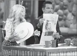  ?? Lorraine Hjalte, Calgary Herald ?? Kelly Ripa and her husband, Mark Consuelos, hold a copy of the Calgary Herald as they tape a show in Banff on Sunday. Reader says Travel Alberta made Banff look like it’s winter all year round.