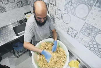  ??  ?? Onion Bhaji being mixed at the Big Fat Indian Kitchen at the Stack, Seaburn.