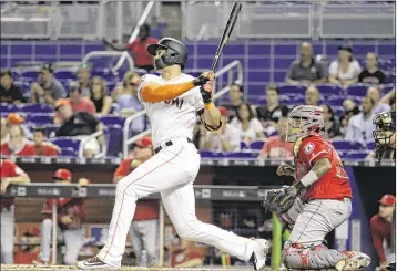  ?? LYNNE SLADKY / ASSOCIATED PRESS ?? Giancarlo Stanton hits a two-run homer Friday to fuel a four-run first inning for the Marlins. It was Stanton’s 12th homer of the season — and the 10th in the past three seasons to travel at least 460 feet.