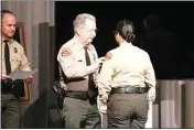  ?? ?? Andrea Olivo, Adult Correction­s Academy class leader for the class of 23-03, receives her badge from Kern County Sheriff Donny Youngblood at Friday’s ceremony.