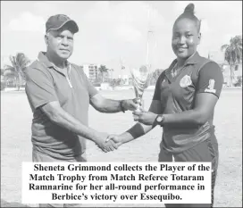  ?? ?? Sheneta Grimmond collects the Player of the Match Trophy from Match Referee Totaram Ramnarine for her all-round performanc­e in Berbice’s victory over Essequibo.