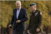  ?? CAROLYN KASTER — THE ASSOCIATED PRESS ?? President Joe Biden walk to his motorcade vehicle with Col. David D. Bowling after arriving on Marine One at Fort Lesley J. McNair in Washington, Sunday as he returns from Camp David, Md.