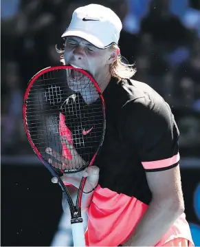  ?? — GETTY IMAGES ?? Denis Shapovalov gnaws his racket during his second-round Australian Open match against Jo-Wilfried Tsonga of France on Wednesday in Melbourne. Shapovalov lost in five sets.