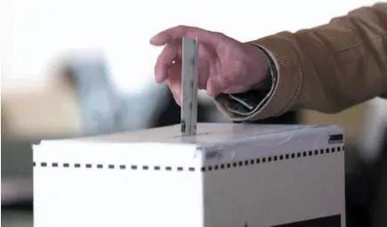  ?? CP FILE PHOTO ?? A voter casts a ballot in the 2011 federal election in Toronto.