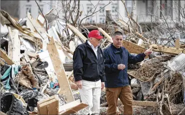  ?? ALEX BRANDON / ASSOCIATED PRESS ?? President Donald Trump speaks with Mike Herrick of the Putnam County Rescue Squad on Friday as he tours damage from a tornado in Cookeville, Tennessee.