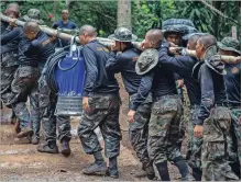  ?? LAUREN DECICCA GETTY IMAGES ?? Thai military members bring water pumps to a cave on Friday in Chiang Rai, Thailand, as part of an ongoing rescue effort for 12 boys and their soccer coach, who have been trapped in a cave for almost two weeks.