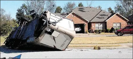  ?? Marc Hayot/Herald Leader ?? A recreation­al vehicle owned by Matt Younkin was flipped on its side by an EF-2 tornado that hit Siloam Springs during the early morning of Oct. 21.