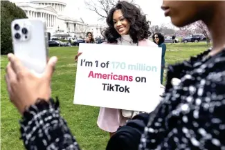  ?? AP PHOTO ?? OPPOSITION
Devotees of TikTok pose with a sign on Capitol Hill in Washington, D.C. on March 13, 2024. TikTok’s extensive lobbying campaign is the latest push since the House passed legislatio­n that would ban the popular app if its China-based owner does not sell its stake.