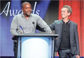  ?? PHOTOS BY FREDERICK M. BROWN GETTY IMAGES ?? Empire director/producer Lee Daniels, left, and producer Brian Grazer accept the Television Critics Associatio­n’s top honor Saturday night in Beverly Hills.