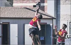  ?? Shotgun Spratling Los Angeles Times ?? MUNIR McCLAIN jumps for a pass, but the freshman receiver sat out practice while in concussion protocol. He is drawing high praise from USC coaches.