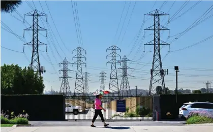  ?? Photograph: Frederic J Brown/AFP/Getty Images ?? Power lines in Rosemead, California. The state will impose income-based electricit­y fees in 2025.