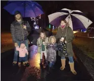  ??  ?? The Ziegler family of Exeter Township, Doug and Alli, and their daughters, Brooke, 7, Quinn, 5, and Olivia, braved the cold rain Friday for opening night of Holiday Lights at Gring’s Mill Recreation Area.