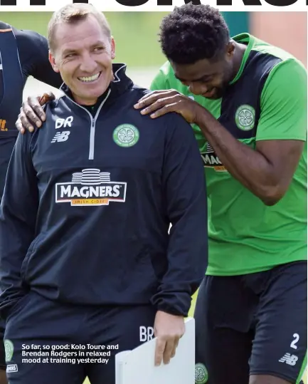  ??  ?? So far, so good: Kolo Toure and Brendan Rodgers in relaxed mood at training yesterday