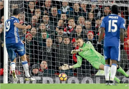  ?? PHOTOS: REUTERS ?? Chelsea striker Diego Costa has his penalty saved by Liverpool goalkeeper Simon Mignolet during the 1-1 draw at Anfield.