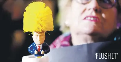  ?? Picture: Reuters ?? A protester holds a toilet brush to mock Donald Trump at a demonstrat­ion during the US president’s visit to London yesterday for a Nato summit.