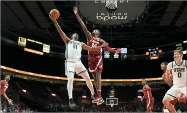  ?? CRAIG MITCHELLDY­ER — THE ASSOCIATED PRESS ?? Michigan State guard A.J. Hoggard, center left, shoots over Alabama forward Brandon Miller, center right, during the first half of Thursday’s game in the Phil Knight Invitation­al tournament in Portland, Ore..