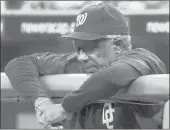  ?? GENE J. PUSKAR/AP ?? Washington Nationals manager Frank Robinson watches a game against the Pittsburgh Pirates from the dugout on June 21, 2005, in Pittsburgh.