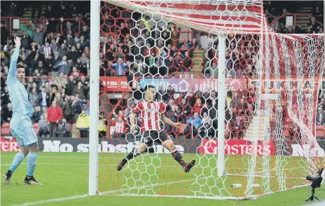  ??  ?? Bryan Oviedo claims in vain as Brentford go into their early lead at Griffin Park on Saturday. Pictures by Frank Reid.