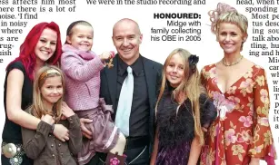  ??  ?? HONOURED: Midge with family collecting his OBE in 2005