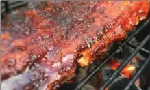  ?? DAVE LOBECK, TNS ?? Try your hand at smoking a rack of ribs this year.