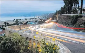  ?? Marcus Yam
Los Angeles Times ?? LIGHT TRAILS are captured with a long camera exposure as cars move up and down the California Incline in Santa Monica, which will undergo a $20-million renovation starting next month.