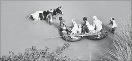  ??  ?? Villagers use tube boats to wade through flooded area of Hajipur, Bihar on Tuesday.