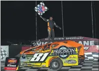  ?? RICH KEPNER - FOR MEDIANEWS GROUP ?? Dylan Swinehart waves the checkered flag atop his car after winning the modified feature Saturday night at Grandview Speedway.