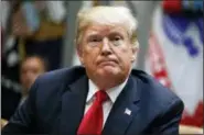  ?? EVAN VUCCI — THE ASSOCIATED PRESS ?? President Donald Trump listens to a question from a reporter during a meeting of the President’s National Council of the American Worker in the Roosevelt Room of the White House, Monday in Washington.