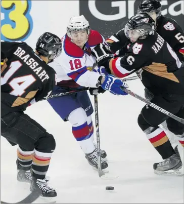  ?? Gavin Young/calgary Herald ?? The Edmonton Oil Kings’ Michael St. Croix is surrounded by three Calgary Hitmen including Brady Brassart, left and Colby Harmsworth, right during WHL action at the Scotiabank Saddledome on Tuesday. Oil Kings won 4-1.