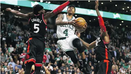  ?? MADDIE MEYER / GETTY IMAGES ?? Isaiah Thomas of the Boston Celtics, who scored 44 points in the game, takes a shot against DeMarre Carroll of the Toronto Raptors and Lucas Nogueira in Boston on Wednesday.