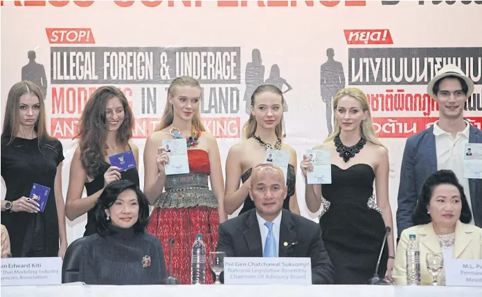  ??  ?? MODEL SUBJECTS: Foreign models show their work permits at a press conference held last week by the Labour Ministry, which has vowed to crack down on models working in Thailand illegally.