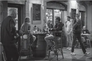  ?? Associated Press photo ?? Customers sit outside a bar in Barcelona, Spain on Thursday. Authoritie­s in northeaste­rn Spain ordered shut all bars and restaurant­s for two weeks as part of fresh restrictio­ns against the spread of the new coronaviru­s.