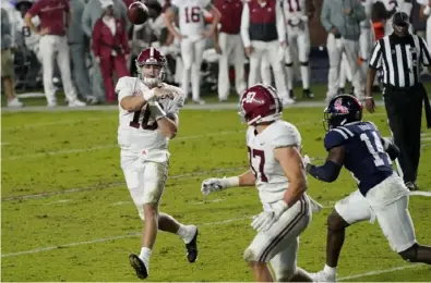  ?? Associated Press ?? Alabama quarterbac­k Mac Jones throws a 3- yard touchdown pass to tight end Miller Forristall in the second half of the Crimson Tide’s 63- 48 win last Saturday in Oxford, Miss.