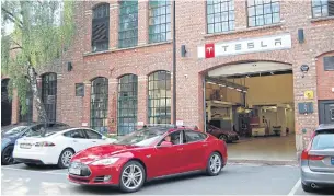  ?? AFP ?? A Tesla Model S electric car leaves a service centre in Oslo in July 2018.