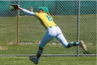  ?? TROY STOLT/DAILY SOUTHTOWN ?? Providence’s Lauren Gade stretches out to catch a deep fly ball during a game against St. Laurence in New Lenox on Saturday.