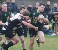  ??  ?? Boyne scrum half Shaun Rooney is dragged down by Dundalk prop forward John Smith.