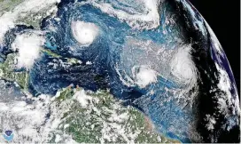  ?? [PHOTO BY NOAA VIA AP] ?? This enhanced satellite image made available by NOAA shows Tropical Storm Florence, upper left, in the Atlantic Ocean on Tuesday. At center is Tropical Storm Isaac and at right is Hurricane Helene.