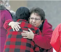  ?? JASON FRANSON/ THE CANADIAN PRESS ?? Family and supporters hug outside of a court hearing concerning the 2016 shooting spree that left four people dead and seven others wounded in La Loche, Sask. on Friday. The judge later affirmed that the young man will be sentenced as an adult.