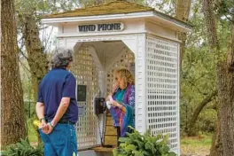  ?? IVY CEBALLO/TNS ?? Laura McCullough gasps as she walks into the wind phone booth. Her husband, Kevin McCullough, stands nearby at Folly Farm Nature Preserve in Safety Harbor. She had come to call her son for his birthday.
VISIT THE WIND PHONE
Folly Farm Nature Preserve at 1562 Dr. Martin Luther King Jr. Street North, Safety Harbor, is free and open every day from 8 a.m. until 6 p.m.