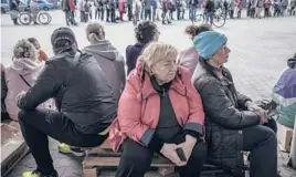  ?? FINBARR O’REILLY/THE NEW YORK TIMES ?? People wait to receive humanitari­an aid Thursday in Kharkiv, Ukraine. A $40 billion package of further U.S. aid stalled the same day in the Senate.