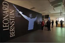  ?? MATT SLOCUM — THE ASSOCIATED PRESS ?? Journalist­s walk through the Leonard Bernstein exhibit during a press preview March 14 at the National Museum of American Jewish History in Philadelph­ia. The exhibit on the acclaimed composer and conductor opens March 16 and runs to Sept. 2.