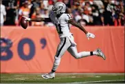  ?? JACK DEMPSEY — THE ASSOCIATED PRESS ?? Las Vegas Raiders wide receiver Henry Ruggs III (11) scores a touchdown against the Denver Broncos during the first half of an NFL football game, Sunday.