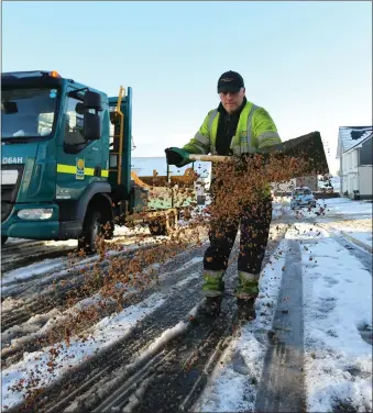  ?? Picture: Colin Mearns ?? A Glasgow city council road worker grits a road in Toryglen, Glasgow as the west of Scotland continues to shiver from low temperatur­es and snow.