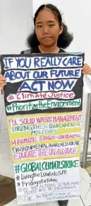  ?? —CONTRIBUTE­D PHOTO ?? SOLO EFFORT Fifteen-yearold Mary Therese Catapang of Calapan City holds a onechild strike against climate change.