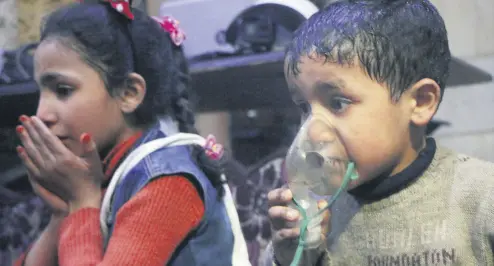  ??  ?? A child receives oxygen through a respirator taken in Douma, April 8.