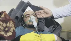  ??  ?? A man receives treatment after the attack on Khan Sheikhoun