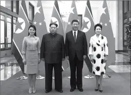  ?? ASSOCIATED PRESS ?? IN THIS PHOTO RELEASED WEDNESDAY BY CHINA’S XINHUA NEWS AGENCY, Chinese President Xi Jinping (second from right) and his wife Peng Liyuan (right) and North Korean leader Kim Jong Un (second from left) and his wife Ri Sol Ju (left) pose for a photo at...